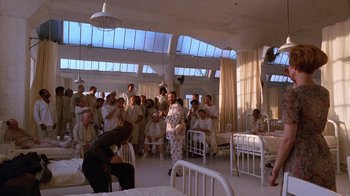 Movie still from “The Fisher King” (1991), directed by Terry Gilliam – A large group of people gathered in a hospital room; Wide shot, High angle