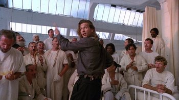 Movie still from “The Fisher King” (1991), directed by Terry Gilliam – A group of men in white robes and one man in a black shirt; Medium shot, Low angle