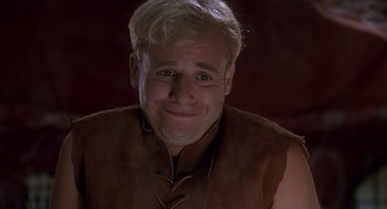 Movie still from “The Flintstones” (1994), directed by Brian Levant – A person wearing a vest; Close Up shot, Low angle