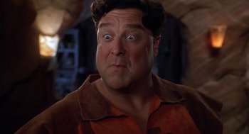 Movie still from “The Flintstones” (1994), directed by Brian Levant – A person with a surprised look on his face; Close Up shot, Low angle