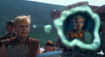 Movie still from “The Flintstones” (1994), directed by Brian Levant – A man and a woman sitting next to each other in front of a mirror; Medium shot, Over the shoulder angle