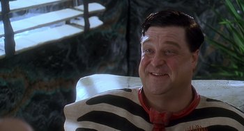Movie still from “The Flintstones” (1994), directed by Brian Levant – A person sitting in a chair; Close Up shot, High angle