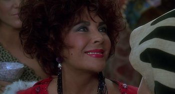 Movie still from “The Flintstones” (1994), directed by Brian Levant – A person wearing a red shirt; Close Up shot, Over the shoulder angle