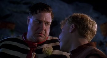 Movie still from “The Flintstones” (1994), directed by Brian Levant – A man and a boy talking to each other; Close Up shot, Over the shoulder angle
