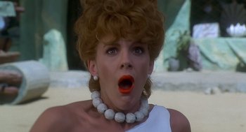 Movie still from “The Flintstones” (1994), directed by Brian Levant – A person wearing a necklace; Close Up shot, Low angle