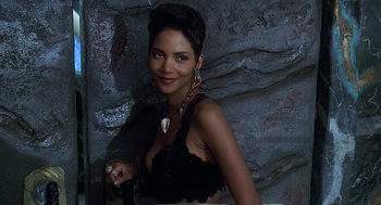Movie still from “The Flintstones” (1994), directed by Brian Levant – A woman in a black bra and a necklace; Close Up shot, High angle