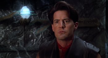 Movie still from “The Flintstones” (1994), directed by Brian Levant – A man that is looking at the camera; Close Up shot, Over the shoulder angle