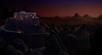 Movie still from “The Flintstones” (1994), directed by Brian Levant – An image of a night time scene with a mountain range in the background; Extreme Wide shot, High angle