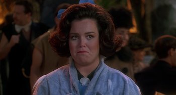 Movie still from “The Flintstones” (1994), directed by Brian Levant – A person wearing a dress; Close Up shot, Over the shoulder angle