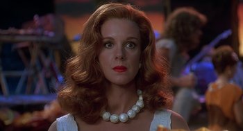 Movie still from “The Flintstones” (1994), directed by Brian Levant – A person wearing a pearl necklace; Close Up shot, Low angle