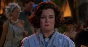 Movie still from “The Flintstones” (1994), directed by Brian Levant – A person wearing a blue shirt; Close Up shot, Over the shoulder angle