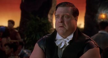 Movie still from “The Flintstones” (1994), directed by Brian Levant – A person wearing a suit and tie; Close Up shot, Low angle