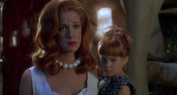 Movie still from “The Flintstones” (1994), directed by Brian Levant – A woman and a little girl standing next to each other; Close Up shot, Over the shoulder angle