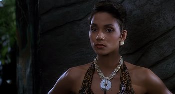 Movie still from “The Flintstones” (1994), directed by Brian Levant – A woman wearing a necklace and a leopard print dress; Close Up shot, Over the shoulder angle