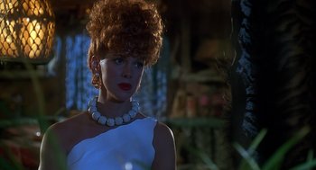 Movie still from “The Flintstones” (1994), directed by Brian Levant – A woman in a white dress with a white necklace; Close Up shot, Low angle