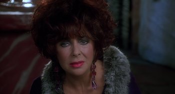 Movie still from “The Flintstones” (1994), directed by Brian Levant – A person wearing a fur coat; Close Up shot, Over the shoulder angle