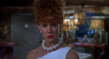 Movie still from “The Flintstones” (1994), directed by Brian Levant – A person wearing a necklace; Close Up shot, Low angle