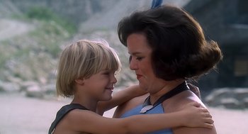 Movie still from “The Flintstones” (1994), directed by Brian Levant – A woman and a boy are hugging each other; Close Up shot, High angle