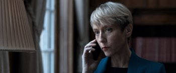 Movie still from “The Foreigner” (2017), directed by Martin Campbell – A woman is talking on a cell phone; Close Up shot, Low angle