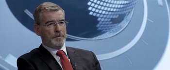 Movie still from “The Foreigner” (2017), directed by Martin Campbell – A person wearing a suit and tie; Close Up shot, Over the shoulder angle