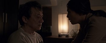 Movie still from “The Foreigner” (2017), directed by Martin Campbell – A man and a woman face to face in a dark room; Close Up shot, Over the shoulder angle
