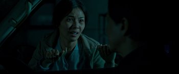 Movie still from “The Foreigner” (2017), directed by Martin Campbell – A woman looking at a man in the mirror; Close Up shot, Over the shoulder angle