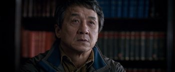 Movie still from “The Foreigner” (2017), directed by Martin Campbell – An older asian man looking at the camera; Close Up shot, Low angle