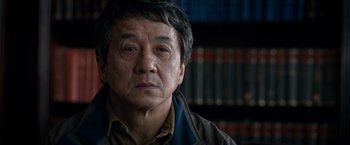 Movie still from “The Foreigner” (2017), directed by Martin Campbell – A person wearing a jacket; Close Up shot, Low angle