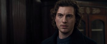 Movie still from “The Foreigner” (2017), directed by Martin Campbell – A person wearing a jacket; Close Up shot, Over the shoulder angle