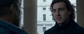 Movie still from “The Foreigner” (2017), directed by Martin Campbell – A person wearing a black jacket; Close Up shot, Over the shoulder angle