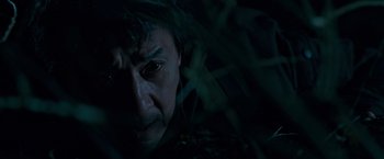Movie still from “The Foreigner” (2017), directed by Martin Campbell – A man's face in the dark; Close Up shot, Low angle