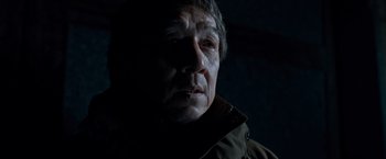 Movie still from “The Foreigner” (2017), directed by Martin Campbell – A person wearing a jacket; Close Up shot, Low angle