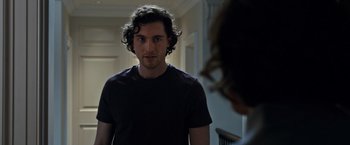 Movie still from “The Foreigner” (2017), directed by Martin Campbell – A man with curly hair standing in front of a woman; Close Up shot, Over the shoulder angle