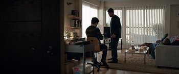 Movie still from “The Foreigner” (2017), directed by Martin Campbell – Two men standing in front of a computer desk; Wide shot, Over the shoulder angle