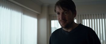 Movie still from “The Foreigner” (2017), directed by Martin Campbell – A person wearing a black t - shirt; Close Up shot, Over the shoulder angle