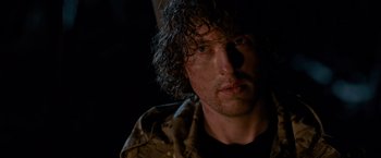 Movie still from “The Foreigner” (2017), directed by Martin Campbell – A person with curly hair; Close Up shot, Over the shoulder angle