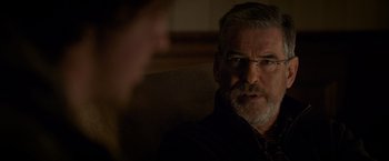 Movie still from “The Foreigner” (2017), directed by Martin Campbell – An older man with a gray beard is talking to a younger man; Close Up shot, Over the shoulder angle