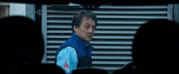 Movie still from “The Foreigner” (2017), directed by Martin Campbell – A person wearing a blue jacket; Close Up shot, Low angle