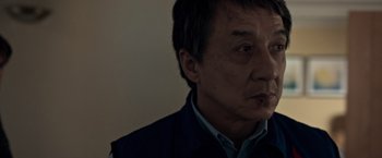 Movie still from “The Foreigner” (2017), directed by Martin Campbell – A person wearing a vest; Close Up shot, Low angle
