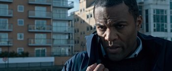 Movie still from “The Foreigner” (2017), directed by Martin Campbell – A person talking on a cell phone; Close Up shot, Over the shoulder angle