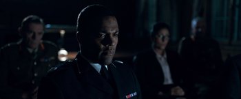 Movie still from “The Foreigner” (2017), directed by Martin Campbell – A man and a woman in a suit and tie in the dark; Medium shot, Over the shoulder angle