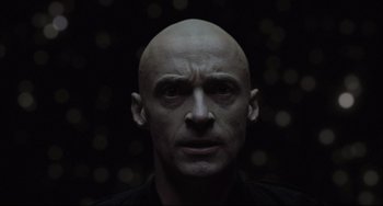 Movie still from “The Fountain” (2006), directed by Darren Aronofsky – A man with a bald head is looking at the camera; Close Up shot, Low angle