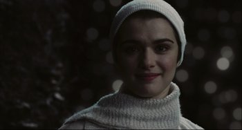 Movie still from “The Fountain” (2006), directed by Darren Aronofsky – A woman wearing a white hat and a white sweater; Close Up shot, Over the shoulder angle