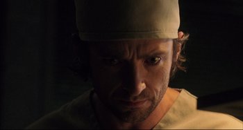 Movie still from “The Fountain” (2006), directed by Darren Aronofsky – A person wearing a hat; Close Up shot, Over the shoulder angle