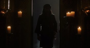 Movie still from “The Fountain” (2006), directed by Darren Aronofsky – A woman standing in the dark with candles; Wide shot, Low angle