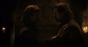 Movie still from “The Fountain” (2006), directed by Darren Aronofsky – Two men are facing each other in the dark; Medium shot, Over the shoulder angle