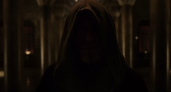 Movie still from “The Fountain” (2006), directed by Darren Aronofsky – A person with a hood is standing in the dark; Close Up shot, Low angle