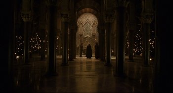 Movie still from “The Fountain” (2006), directed by Darren Aronofsky – A man in a black robe standing inside a building; Extreme Wide shot, High angle