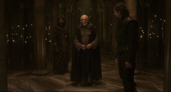 Movie still from “The Fountain” (2006), directed by Darren Aronofsky – A group of people standing around in a room; Wide shot, Over the shoulder angle