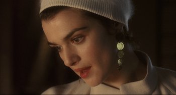 Movie still from “The Fountain” (2006), directed by Darren Aronofsky – A person wearing a hat and earrings; Close Up shot, High angle